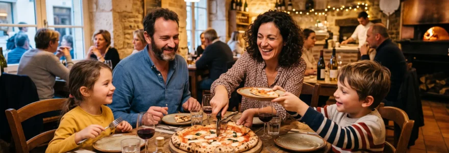 Une famille partage une grande pizza artisanale autour d'une table en bois dans une pizzeria au décor rustique français